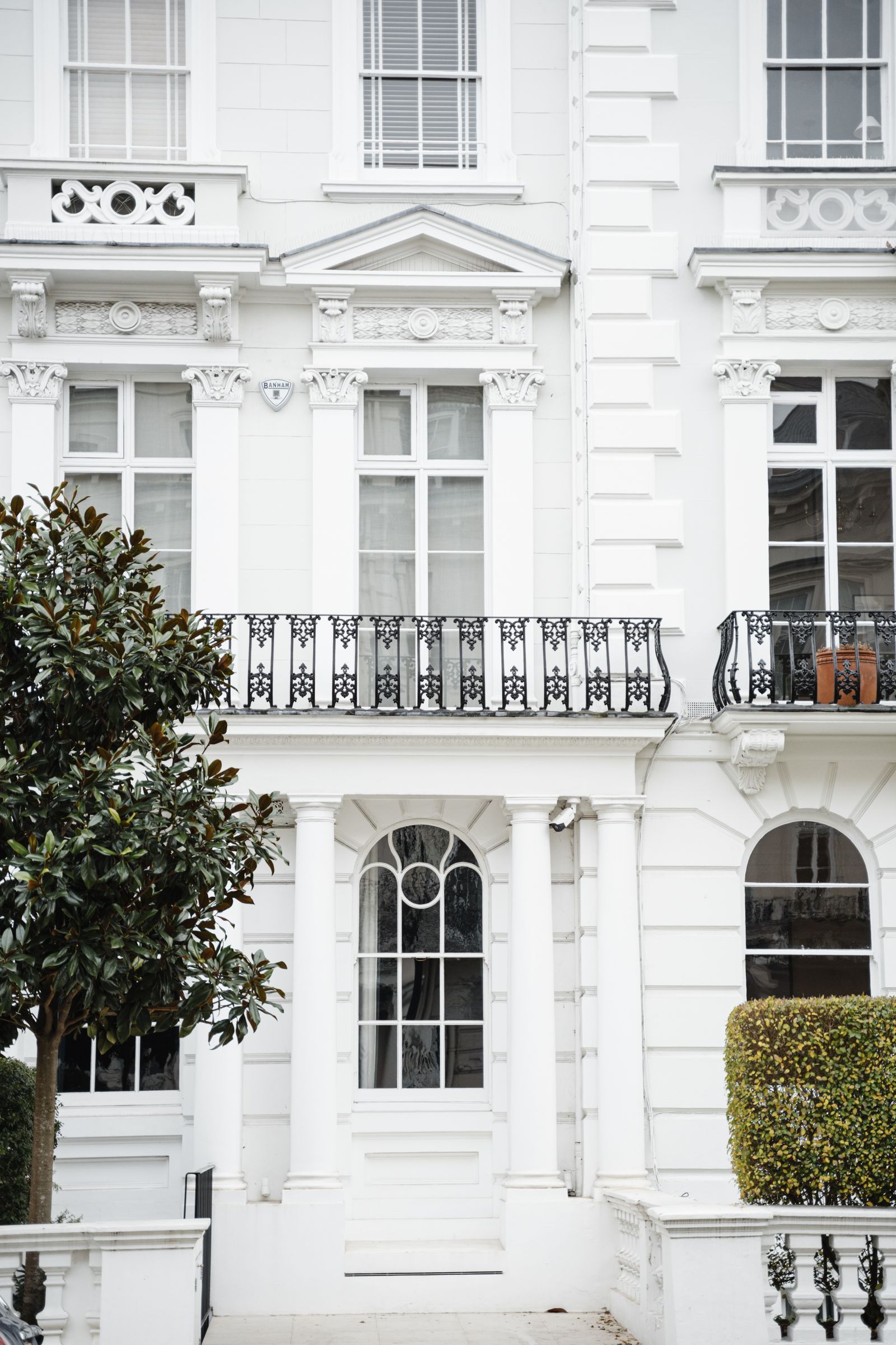 White Victorian townhouses with decorative balconies in London